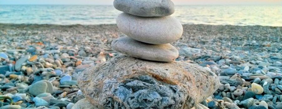 Stacked stones representing balance and alignment in Structural Integration bodywork