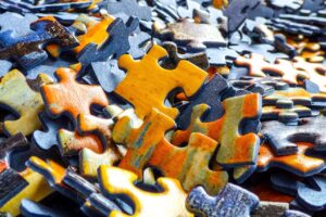 Structural Integration represented by puzzle pieces coming together, symbolizing fascia alignment and whole-body organization often associated with Rolfing bodywork.