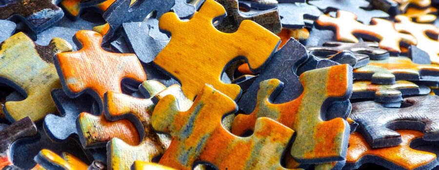 Structural Integration represented by puzzle pieces coming together, symbolizing fascia alignment and whole-body organization often associated with Rolfing bodywork.