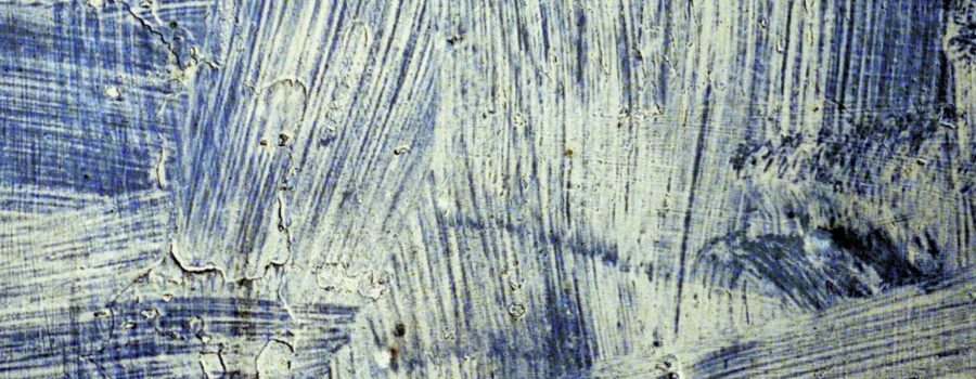 Abstract textured surface with blue and white brush strokes in layered patterns.