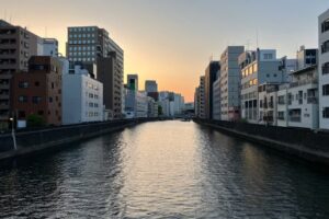 River in Tokyo with buildings on both banks, an image of depth and perspective that mirrors the relationship between posture and how we experience the world.
